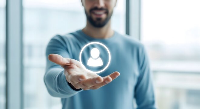 Businessman holding floating glowing user profile icon for human resources concept