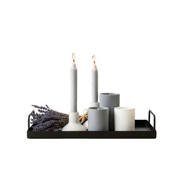 White candles on a tray indoors.
