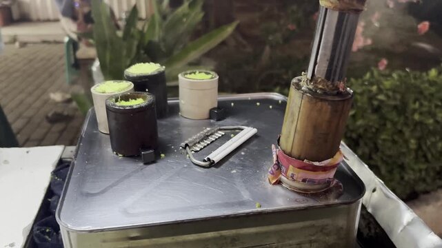 Close-up video featuring traditional kue putu, a steamed rice flour dessert commonly sold by street vendors.