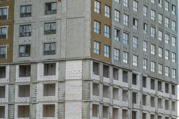 Fototapeta premium New apartment building under construction with no workers present at the site during the day