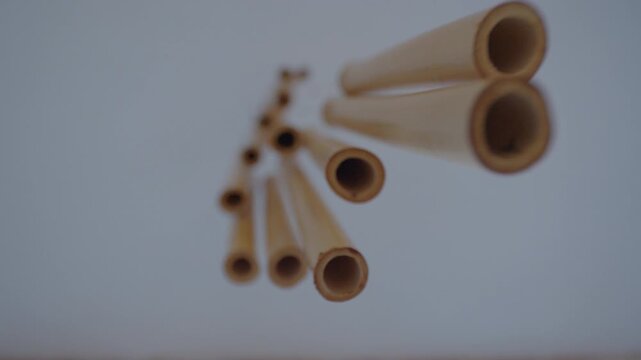 Close-up of a bamboo wind chime hanging against a soft blurred background