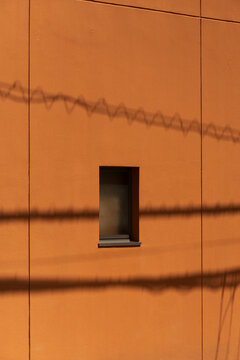 orange brown cement wall with window and line shadow background	