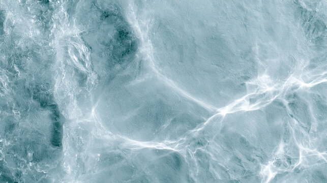 Abstract top view water surface with glowing bright sunlight reflections and ripples
