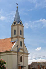 Fototapeta premium Historic Village Church Steeple With Clock Tower, church of St. Andrew the Apostle in Andrijasevci, Croatia