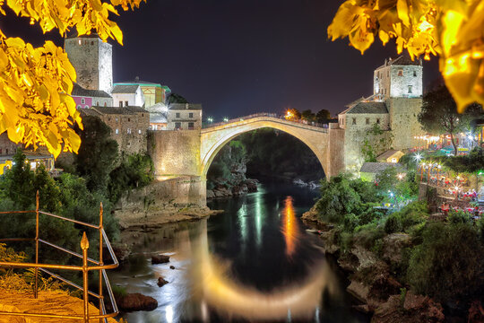 Amazing evening view of Mostar with the Mostar Bridge, houses and minarets, at evening.