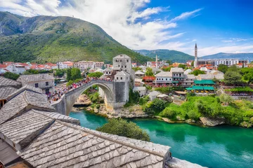 Awesome Skyline of Mostar with the Mostar Bridge, houses and minarets, during sunny day. © pilat666