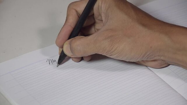 Close-up video of a person writing the words &ldquo;My Diary&rdquo; in a lined notebook with a pen. The footage captures a personal journaling moment, symbolizing self-reflection, daily planning, memories, creati