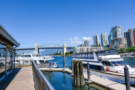 Canada,Vancouver-Jun,21:Luxury yacht docked at False Creek marina with modern residential skyscrapers background in Vancouver, British Columbia, Canada.