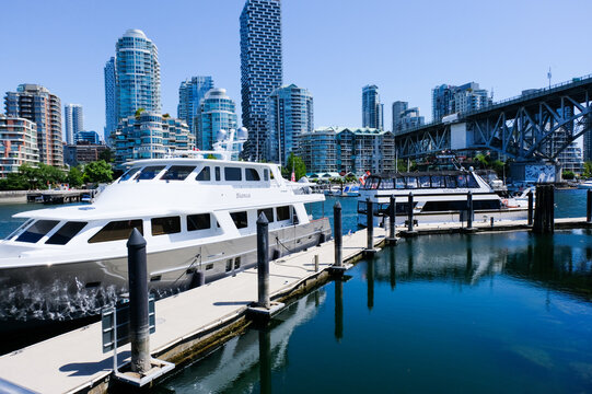 Canada,Vancouver-Jun,21:Luxury yacht docked at False Creek marina with modern residential skyscrapers background in Vancouver, British Columbia, Canada.