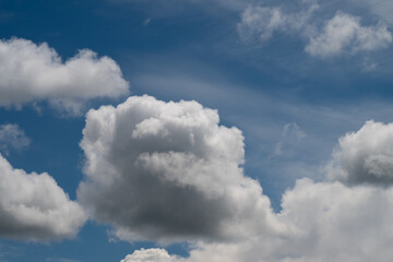 Bright blue sky with clouds. Sunny sky with fluffy cloud formations and open space. Deep blue sky featuring softedged cumulus clouds and extensive space for travel themes © beholdereye