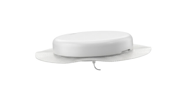 Medical sensor: A close-up shot of a white, round medical sensor device, possibly a continuous glucose monitor, with a clear adhesive base, resting on a white surface.