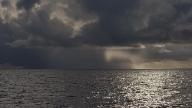 Dark Atlantic Ocean and stormy clouds as seen from the moving sailing boat