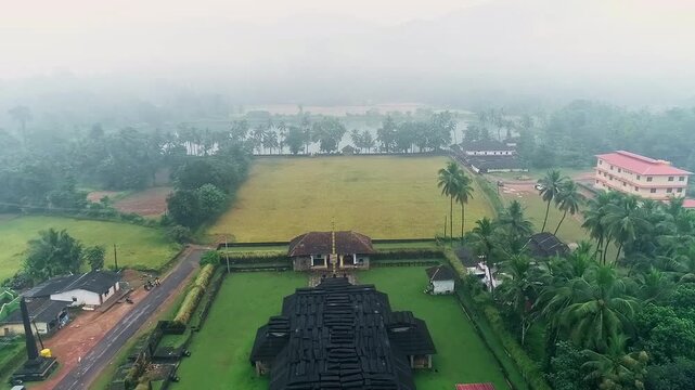 Aerial view of serene Kere Basadi temple floating within varanga Lake heritage landscape scenery
