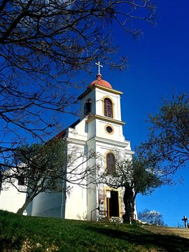 Historic Hilltop Church Under a Deep Blue Sky