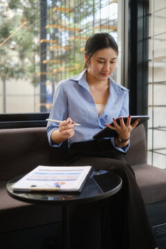 businesswoman managing online tasks and documents on digital tablet, suitable for technology, productivity, and flexible work concepts.