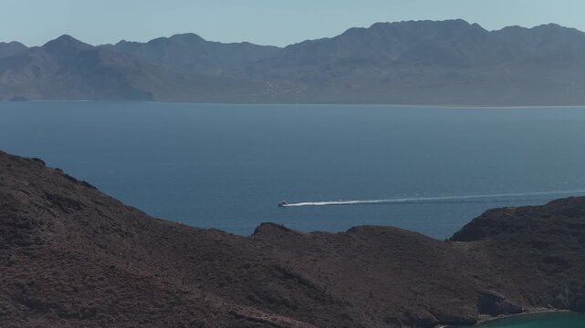 Aerial of the blue Sea of Cortez and a faraway desert range near La Paz Baja California Sur