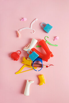 concept for consumerism - collection of miniature doll accessories including boots, handbags, and hangers