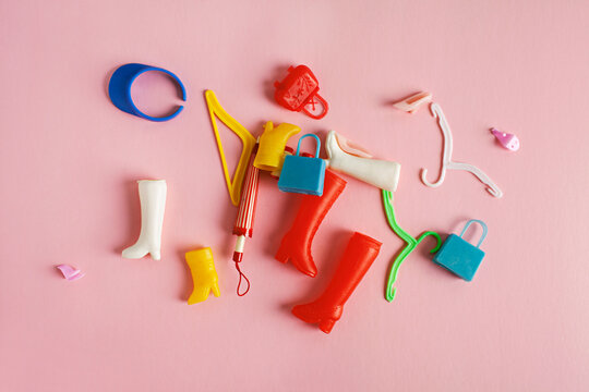 concept for consumerism - collection of miniature doll accessories including boots, handbags, and hangers