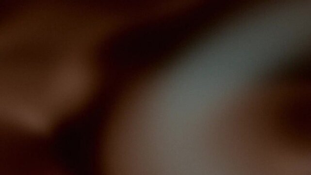 Abstract grainy background with dark moody colors and light leak effect