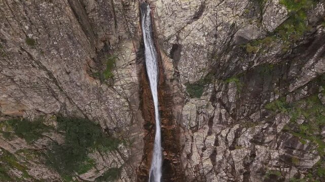 Piscina Irgas Waterfall Over Steep Rugged Cliffs In The Linas Mountains of Sardinia, Italy. Aerial Tilt-up Shot