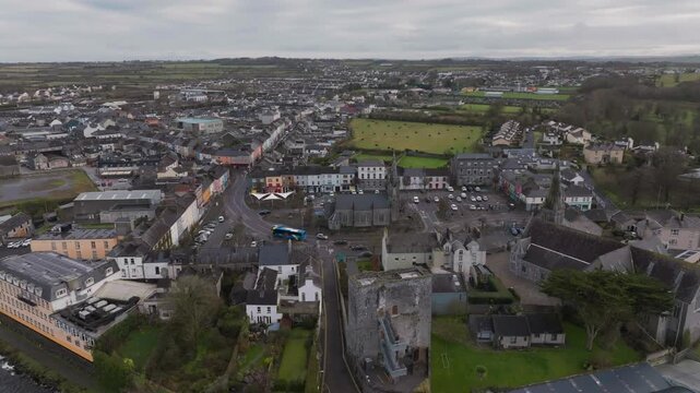 A high angle drone perspective of Listowel village in Kerry, Ireland, showing the historic square, church, and authentic Irish town architecture.