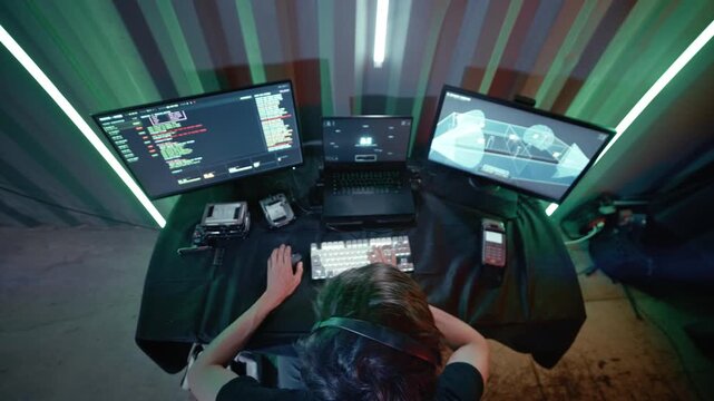 An cyber intruder operates from a mobile unit, systematically bypassing security protocols to take over live video feeds. 
