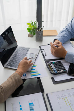 Asian businesswoman showing information on laptop