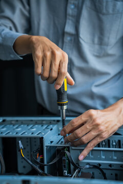 Asian IT engineer using screwdriver fix pc case