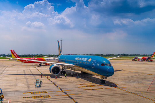 Ground crew worker near a commercial jet engine on the apron in Ho Chi Minh City