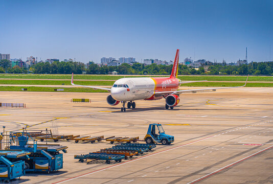 Ground crew worker near a commercial jet engine on the apron in Ho Chi Minh City