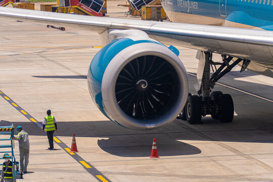 Ground crew worker near a commercial jet engine on the apron in Ho Chi Minh City
