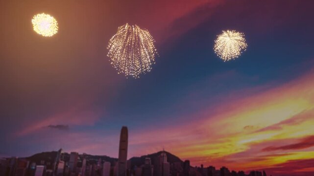 A stunning fireworks display over Hong Kong's skyline during a vibrant sunset.