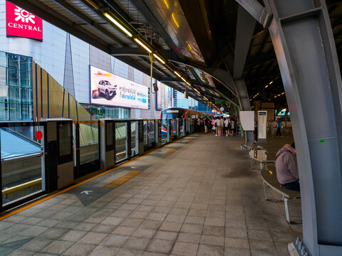 Bangkok, Thailand - July 8, 2026 :  The BTS Skytrain runs in and out of Ha Yaek Lat Phrao Station in the evening, offering views of office buildings and beautiful scenery. illustrative