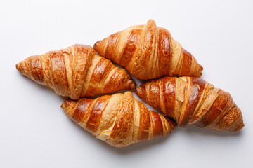Diamond-shaped croissants isolated on a light background © Cavan