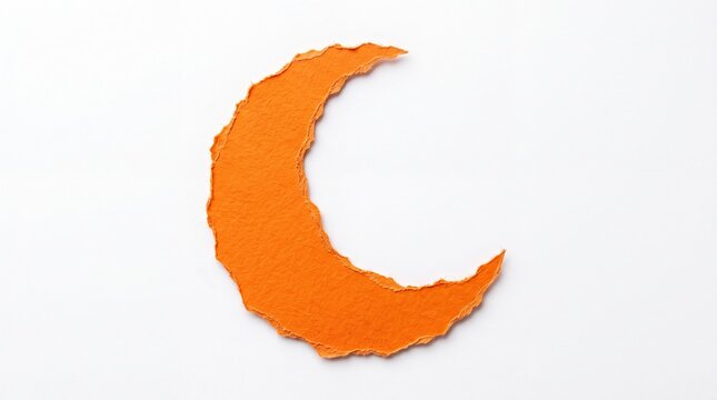 Orange paper crescent moon shape with rough torn edges