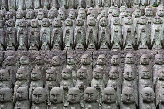 Rows of Jizo stone statues at a Buddhist temple in Kamakura, Japan
