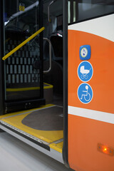 Bus buttons for wheelchair on entrance for people with disabilities and parents with baby carriages. Alert the bus driver to the need for assistance. © SKfoto GE