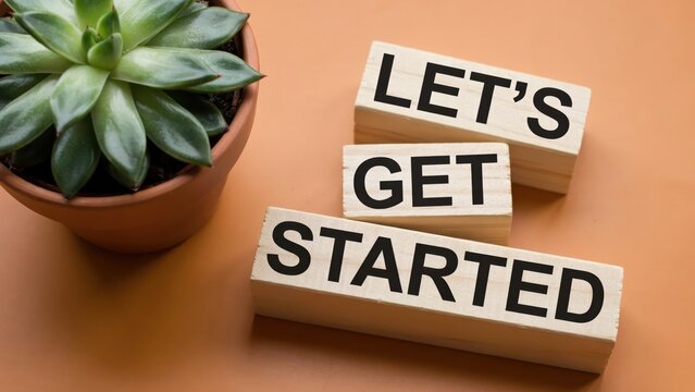 Let's Get Started text on wooden blocks with a succulent plant in a pot, concept of new beginning.