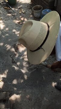 Young Worker Mixing Water into Sand and Cement Heap Using Shovel