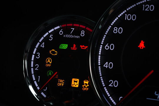 Close-up of modern car dashboard displaying multiple warning lights and indicators