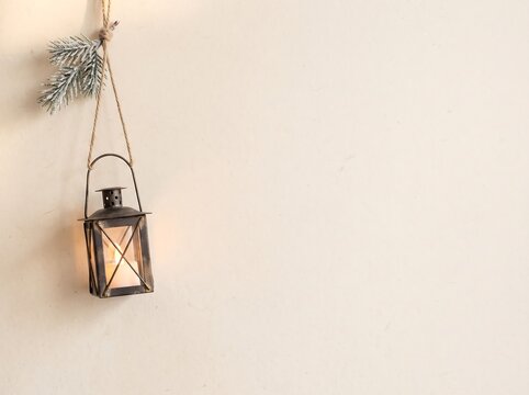 Scandinavian Minimal Christmas Background with Cozy Winter Lantern, Pine Branches and Copy Space