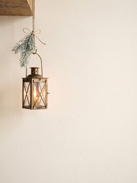 Scandinavian Minimal Christmas Background with Cozy Winter Lantern, Pine Branches and Copy Space