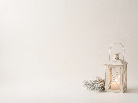 Scandinavian Minimal Christmas Background with Cozy Winter Lantern, Pine Branches and Copy Space