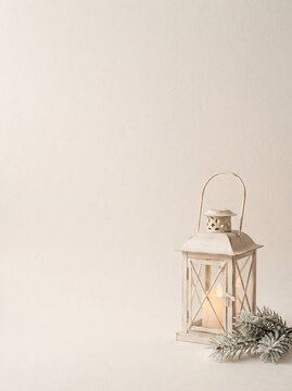 Scandinavian Minimal Christmas Background with Cozy Winter Lantern, Pine Branches and Copy Space