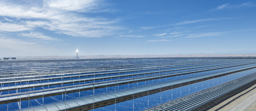 Panoramic Aerial View of Linear Fresnel Solar Mirrors with Glowing Molten Salt Tower in Gobi Desert