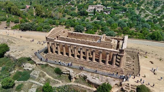 Agrigento in Sicily, Italy. Cinematic aerial drone 4K view of the Temple of Concordia, the largest Doric temple built by the ancient Greeks, in the Valley of the Temples archaeological park.