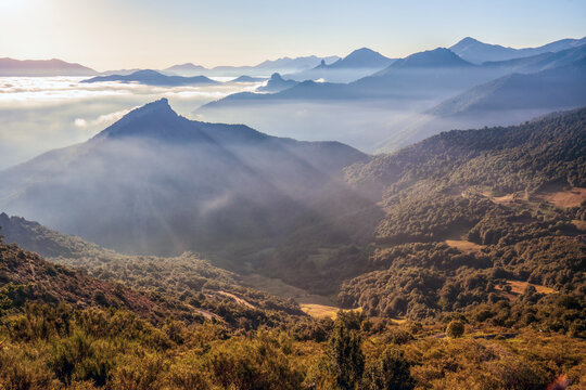 View of the mist-shrouded valleys and mountains of the Picos de Europa from the Collado de Llesba viewpoint, Cantabria, Spain