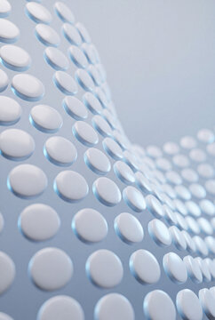 Close-up of white pills arranged in a curved wave formation