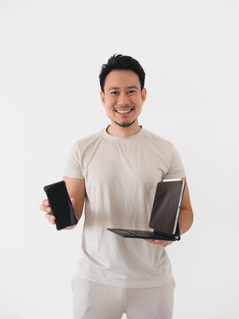 Smiling Asian Man Holding Smartphone and Tablet with Keyboard, Showcasing Modern Technology