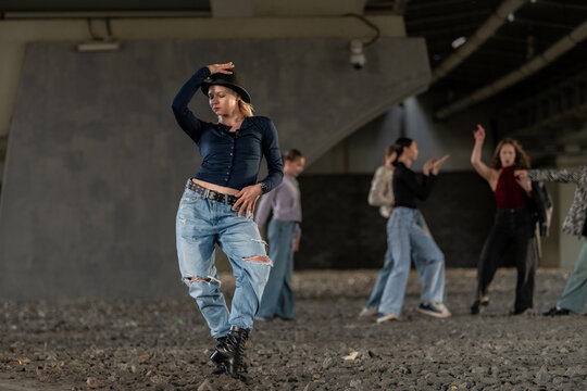 Female street dancer posing in an underpass